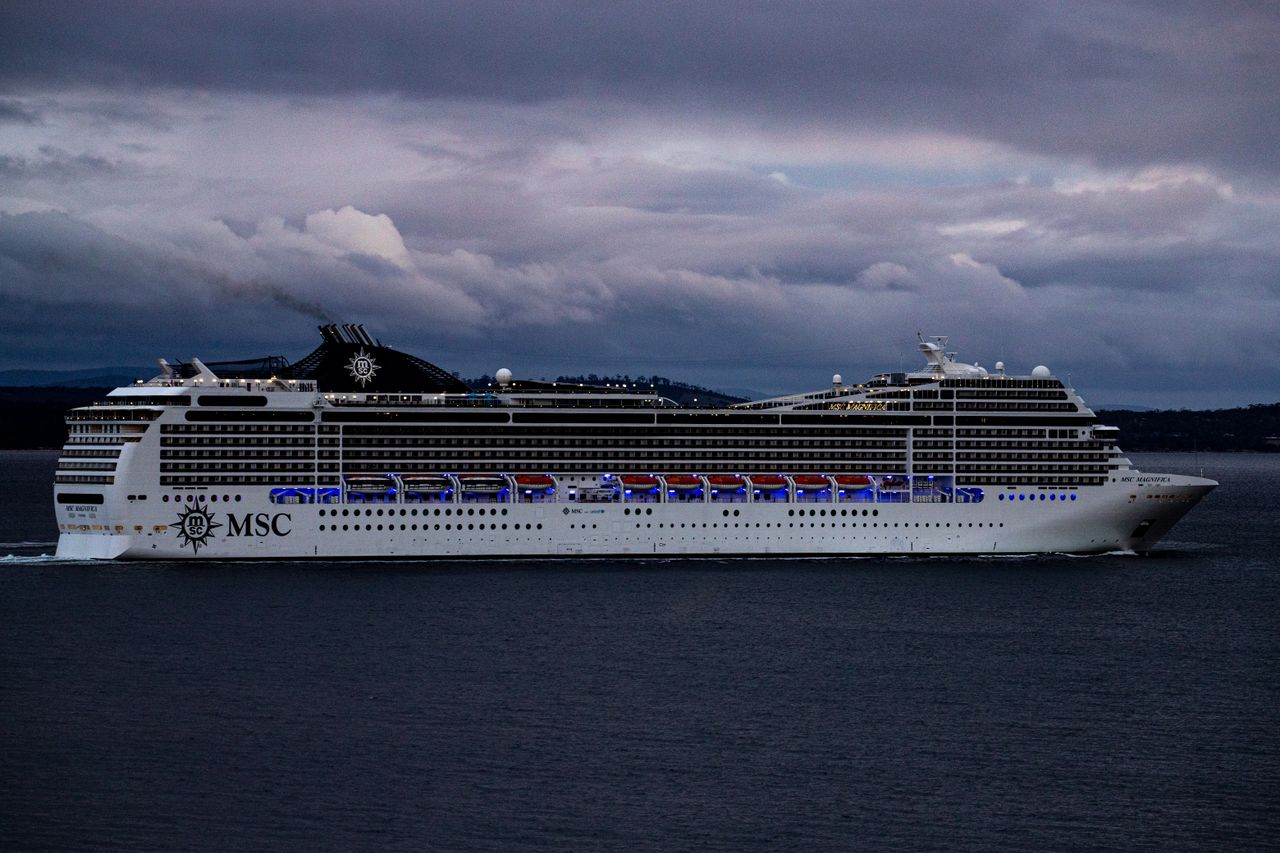 heros-img MSC cruise ship navigating waters near Hobart, Tasmania against a dramatic cloudy sky.